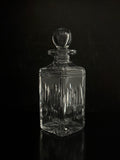 Clear glass decanter with a dark background