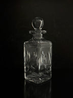 Clear glass decanter with a dark background