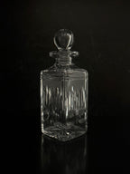 Clear glass decanter with a dark background